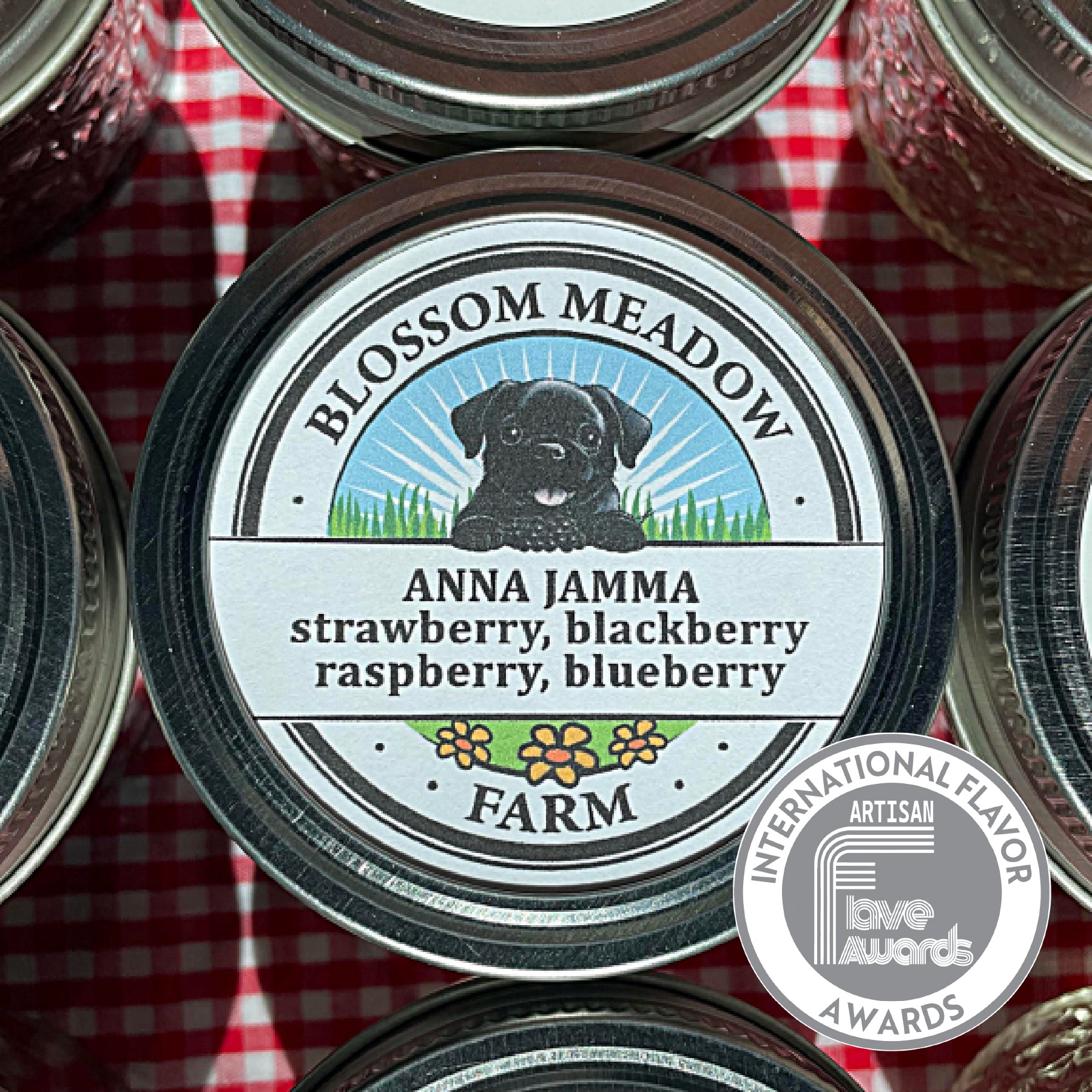 Blossom Meadow Farm's jar of Anna Jamma Jam which features a dog illustration the lid. The jar is on a red and white checkered background.