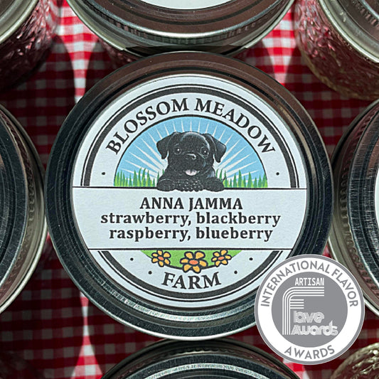 Blossom Meadow Farm's jar of Anna Jamma Jam which features a dog illustration the lid. The jar is on a red and white checkered background.