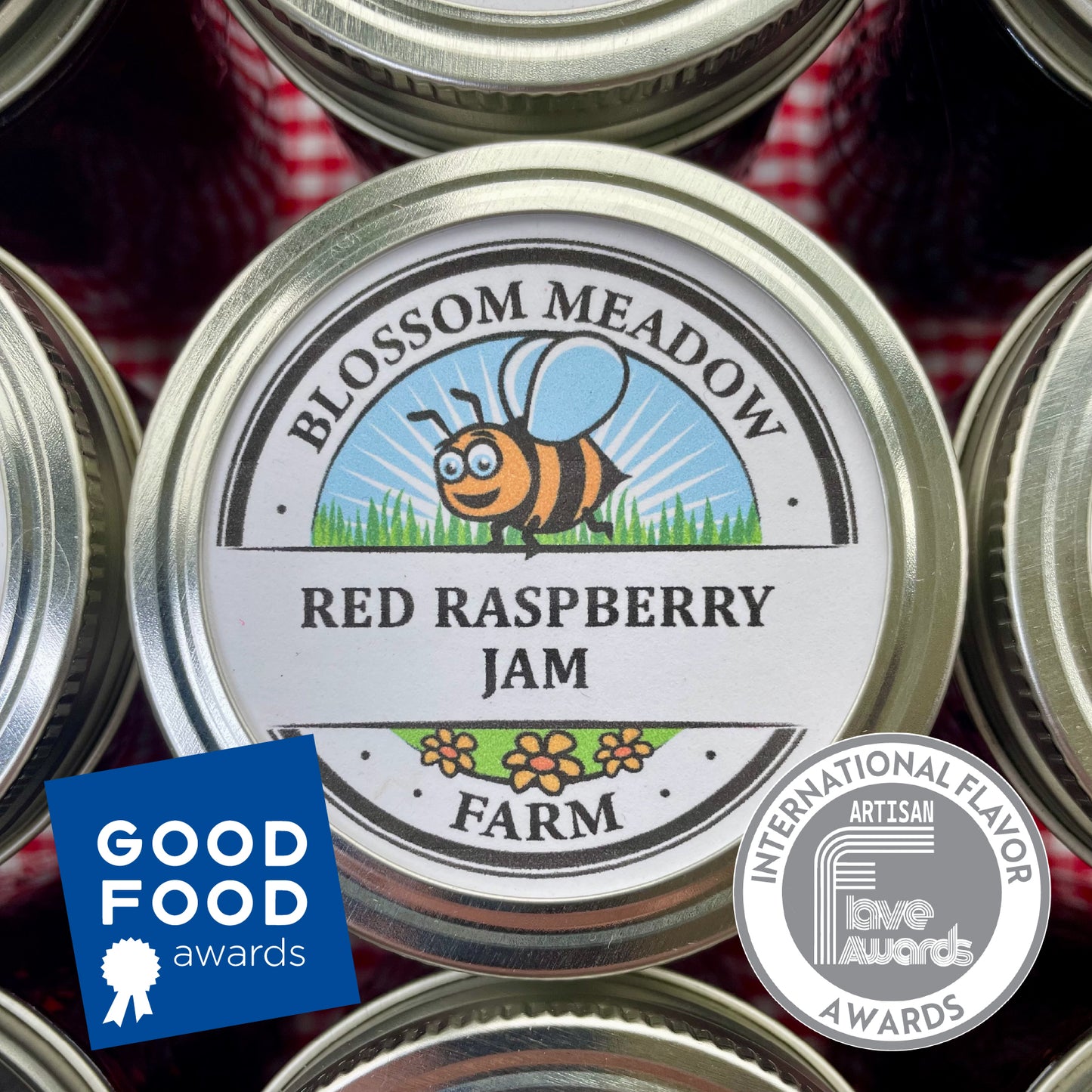 Blossom Meadow Farm Red Raspberry Jam jar with Good Food and International Flavor Award badges on a checkered fabric background